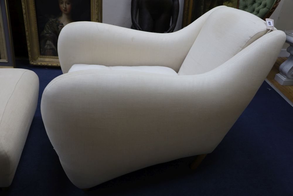 A contemporary upholstered club armchair and foot stool